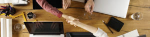 top view of business handshake over desk