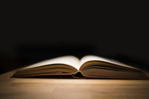 old book with dark background - Menttium