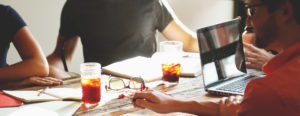 group of coworkers working on wooden table