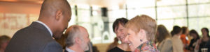 Menttium staffing laughing with each other at conference