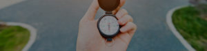 Man hand holding a compass on the forked road