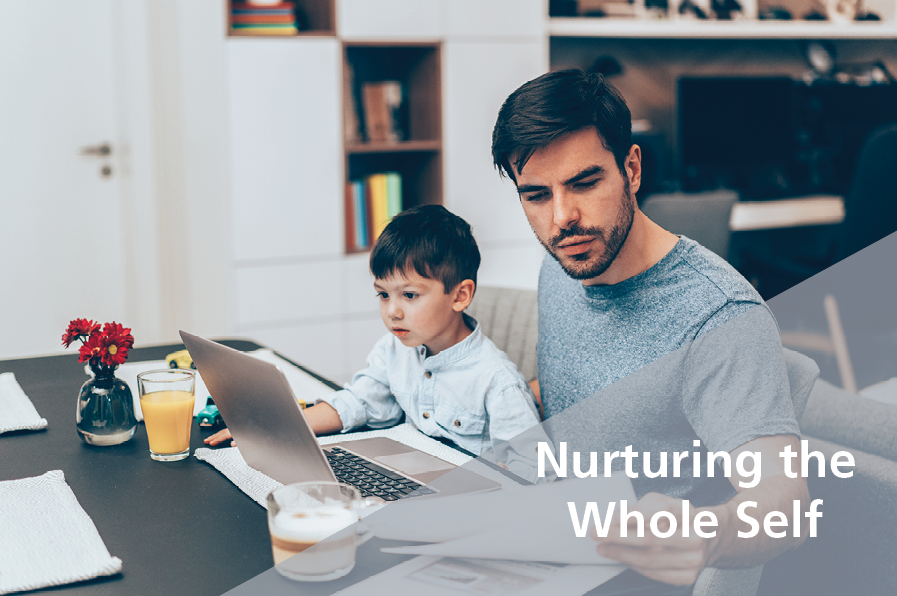 man working on laptop with son on lap - Nurturing the Whole Self - TED Talks