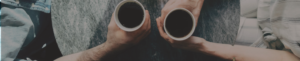 two people holding coffee mugs