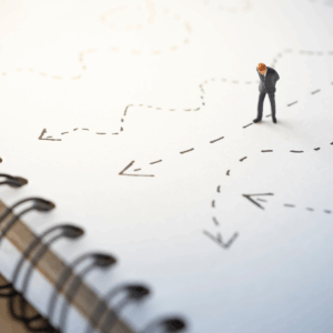 Small figure at a crossroads of dotted arrows, representing mindful decision-making in complex environments.